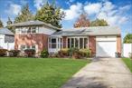 Great location!. Private neighborhood tucked into the heart of Commack. This brick home features newly redone hardwood floors, freshly painted and kitchen that was updated in 2014. The living room has high ceilings and floor to ceiling windows that brings in beautiful natural light. The kitchen has cherry cabinets and stainless appliances with sliders that lead to the yard. There are two bedrooms and a full bath on the second floor and there is one bedroom below on the lower level with a half bath. The den on the lower level has nice tile flooring and an outside entrance. The basement also features the same white marblelike tile and is another great space to entertain. There is a separate laundry room down there and the utility closet. Very nice house. The house sits on .25 acre and is a clean rectangle with room for a pool. Refrigerator GE 2014, Gas range 2014, Dishwasher 1 year old, Washer and Dryer are Samsung and are 5 years old, Water Heater is 2 years, Roof is 20 years, Cesspool 1 year with 2 rings, CAC 20 years, New Garage Door Opener. Priced to sell.