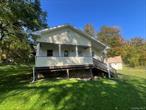 Two bedroom home with vaulted ceilings and primary bedroom suite with sliding glass door to balcony overlooking yard. Converted detached garage which was previously finished into a studio-style cottage. In-ground pool on site.  Minutes to Route 84 access and Taconic State Parkway. Offers to be presented with proof of funds or rehab loan prequalification letters. Sold as-is. Buyer to pay NYS and any local transfer taxes. **Please see agent remarks for access, showing instructions and offer presentation remarks.** Additional Information: HeatingFuel:Oil Above Ground,