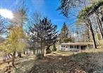 The quintessential hunters&rsquo; cabin from the 1950&rsquo;s on one of the prettiest roads in Sullivan County that backs up to the Ulster County line. Mature landscaping and seasonal views of the Shawangunk Mountain range. This charming cottage - being sold &rsquo;&rsquo;as is&rsquo;&rsquo; - needs updates but once refreshed, it will be well worth the effort. The back of the land rises up and offers more views in the distance and if the cottage is for overflow guests, a new build could be towards the top of the land offering privacy for each structure, as well as more views. &rsquo;&rsquo;L&rsquo;&rsquo;shaped layout: living room &rsquo;&rsquo;L&rsquo;s&rsquo;&rsquo; off the center kitchen and the bathroom/bedrooms are in the other &rsquo;&rsquo;L&rsquo;&rsquo;. A small room w/ laundry hook up is off the kitchen as well. Sweet front porch entry. Tempaloni has had two very modern new builds as of late, and proves others have recognized the road&rsquo;s beauty and privacy. Minutes to amenities in Ellenville, Mountaindale, and Wurtsboro. The Bashakill is close by for seasonal kayaking. Come view this lovely offering and see its potential!