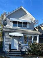 Fully renovated single family home offering three bedrooms plus an additional first-floor room and two full bathrooms. This residence features hardwood floors throughout and a finished basement with its own walk-out entrance. A private driveway provides convenient off-street parking. The Jamaica LIRR station is approximately 0.8 miles away, offering service to the city and connections to the AirTrain for JFK International Airport.